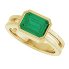 Vibrant emerald-cut emerald ring in 14K yellow gold, modern cocktail style.