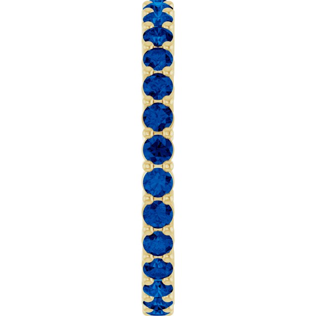 Minimalist yellow gold stacking ring set with sustainably sourced Sapphire gems.