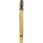 Slim yellow gold birthstone band with rich blue sapphires