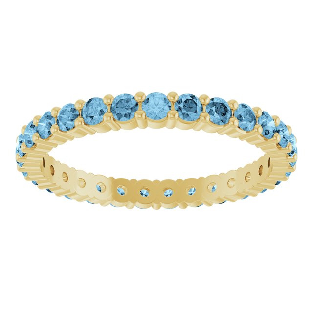Ethical Swiss Blue Topaz ring in solid 10K yellow gold with a full circle of 2mm gemstones.