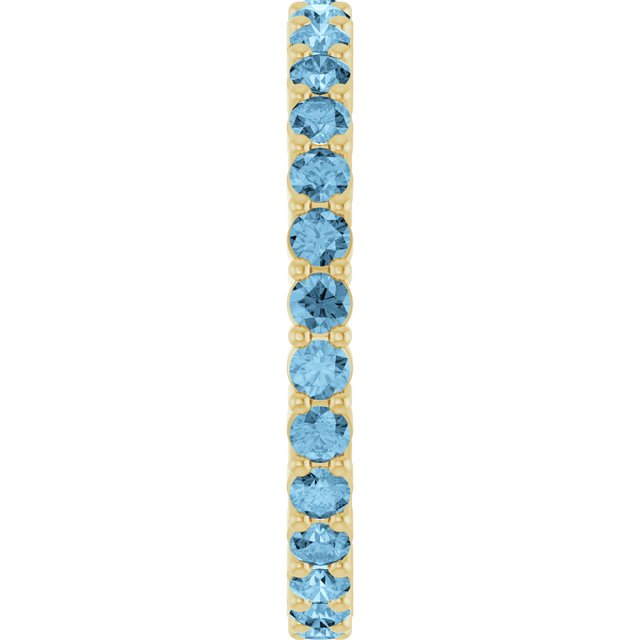 Minimalist yellow gold stacking ring set with sustainably sourced Swiss Blue Topaz gems.