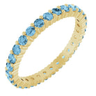 Swiss Blue Topaz eternity ring in 10K yellow gold, handcrafted using recycled metal.