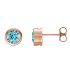 Blue zircon bezel stud earrings side view in 14K rose gold