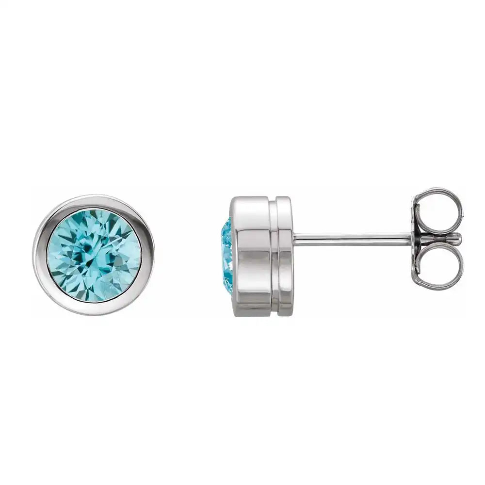 Blue zircon bezel stud earrings side view in sterling silver