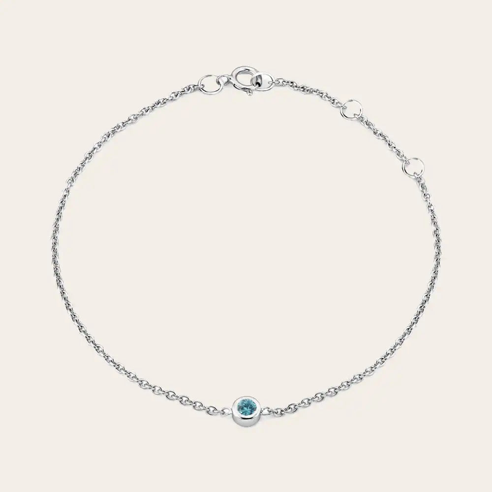 Model wearing bezel-set birthstone bracelet. silver variant--Sterling-silver