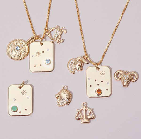editorial ly flat image with zodiac charms styled on chains