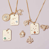 editorial ly flat image with zodiac charms styled on chains