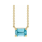 Minimalist 14K yellow gold Zircon birthstone necklace featuring a 5x3mm emerald-cut pendant.