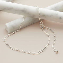 Sterling silver paperclip chain necklace, artfully handmade in the USA, shown styled as a modern layering piece. variant--Sterling-silver
