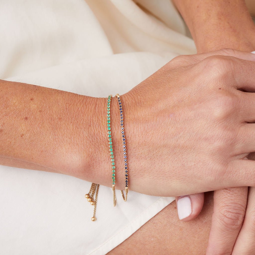 Adjustable tennis bracelet in 14K gold worn on wrist