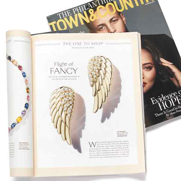 Gold angel wings earrings shown in town and country magazine