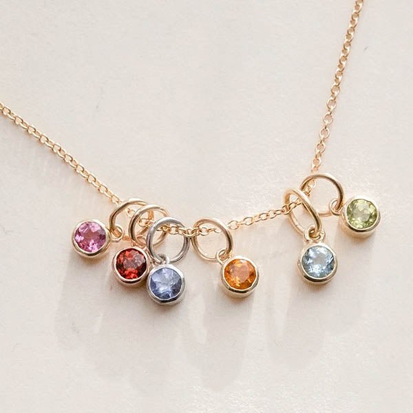 Clustered 14k gold bezel-set birthstone charms — colorful, personalized jewelry for layering or gifting