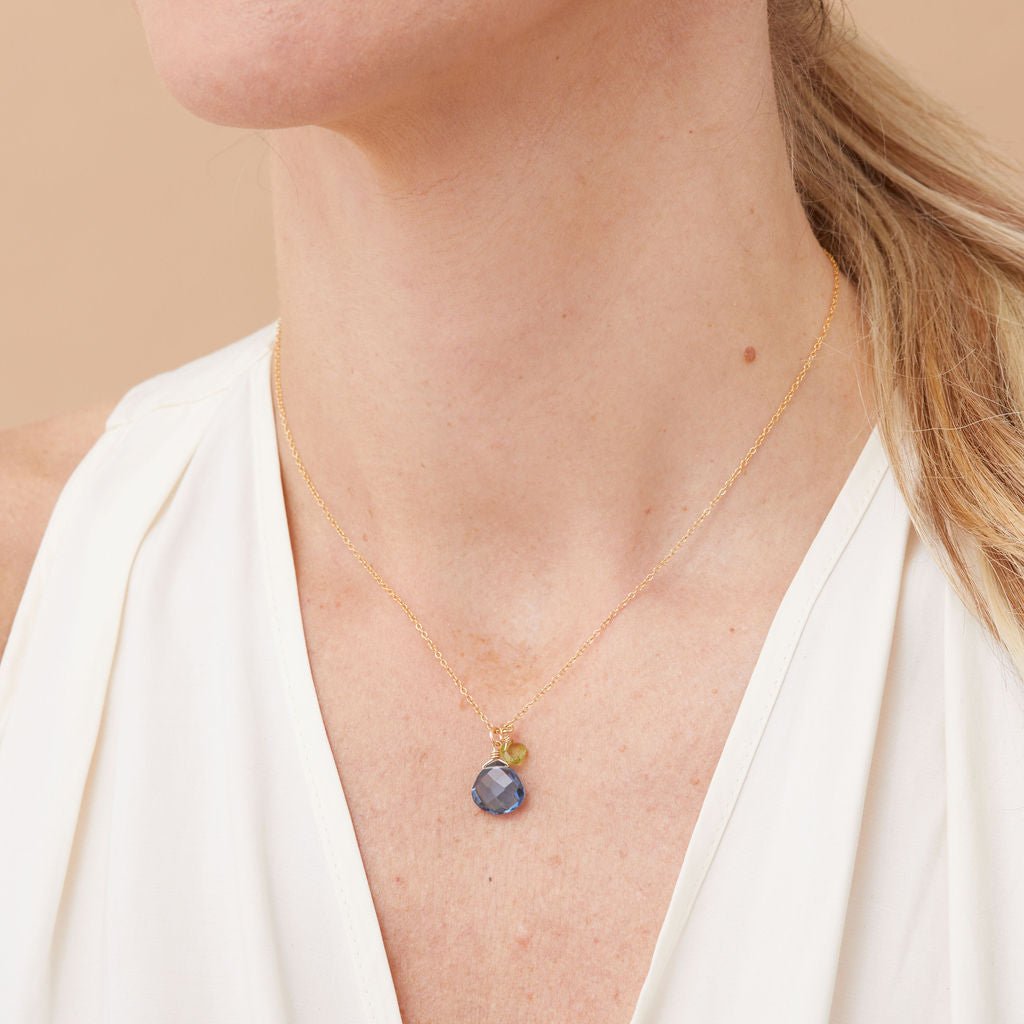 Model wearing customizable two-stone necklace in gold