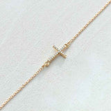 14K yellow gold sideways cross necklace with natural diamond accents