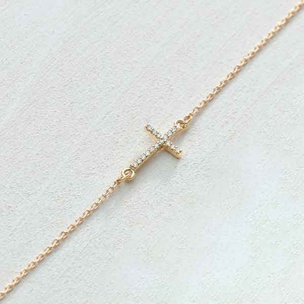 14K yellow gold sideways cross necklace with natural diamond accents