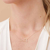 Aries zodiac constellation necklace with natural diamonds in 14K gold shown on model