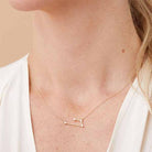 Aries zodiac constellation necklace with natural diamonds in 14K gold shown on model
