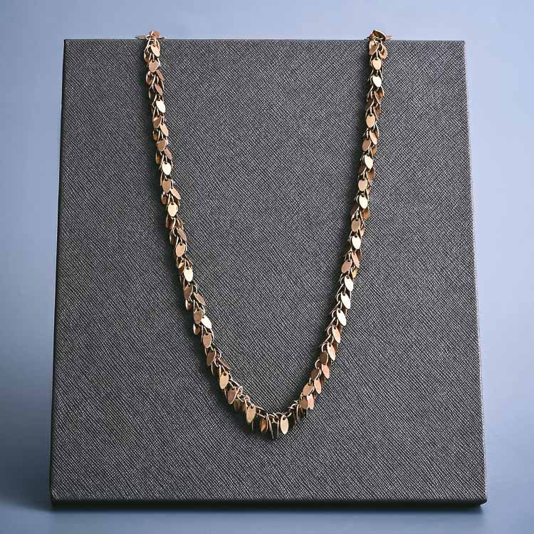 Gold-fill shaker chain at 20-inch length, layered styling on model