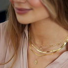 Fine jewelry herringbone necklace featuring high-polish flat gold chain links.