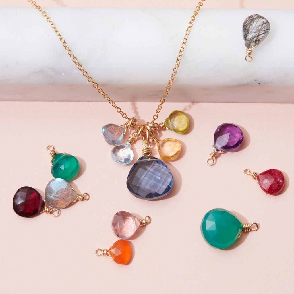Custom birthstone necklace with five colorful stones in gold