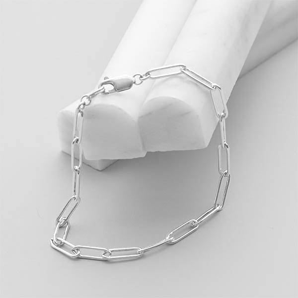 Sterling silver paperclip bracelet styled for layering