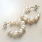 lose-up of lustrous white pearl hoop earrings