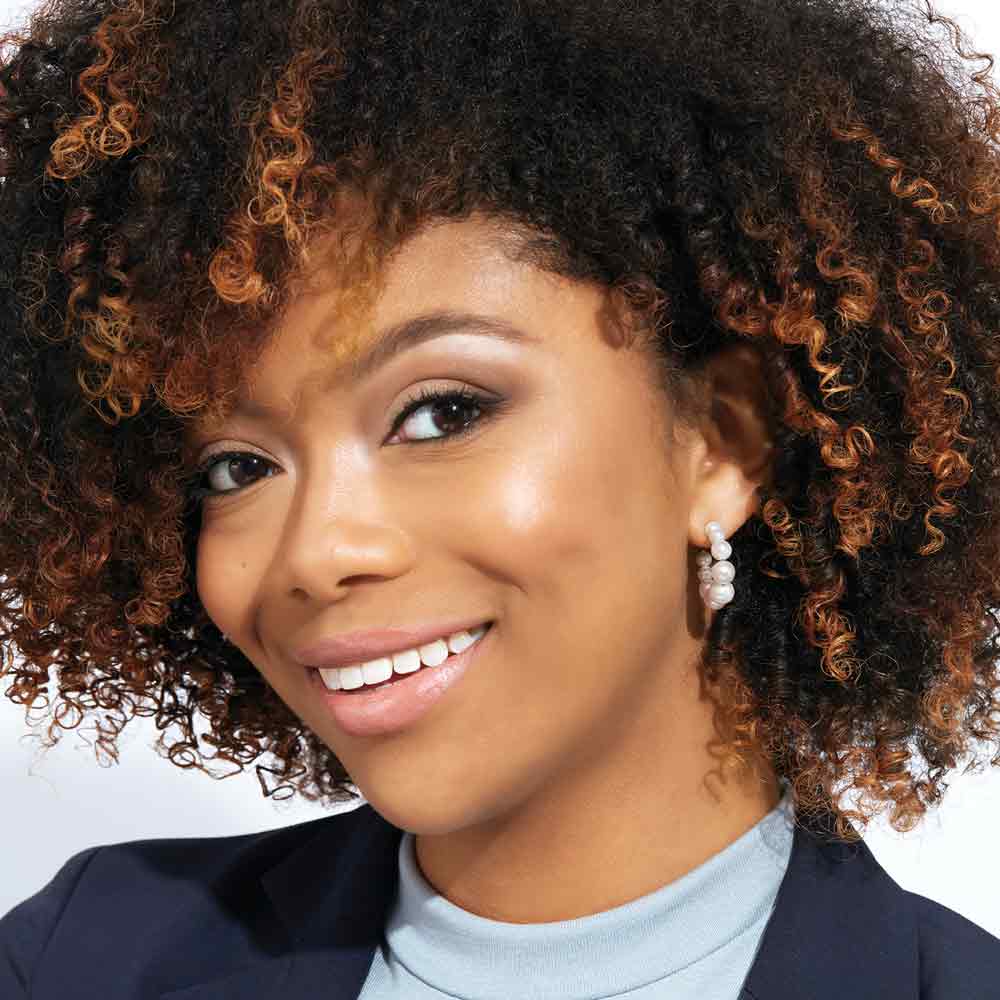 Pearl hoop earrings worn on model for size reference