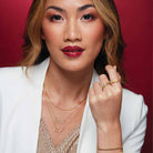 Taurus constellation necklace in gold with flush-set diamonds styled with name plate on model